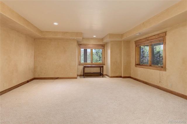 unfurnished room featuring recessed lighting, a healthy amount of sunlight, baseboards, and carpet