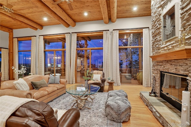 4440 Monitor Rock Ln, Colorado Springs, CO 80904 - living room featuring a wood ceiling with exposed beams, wood finished floors, a stone fireplace, and recessed lighting