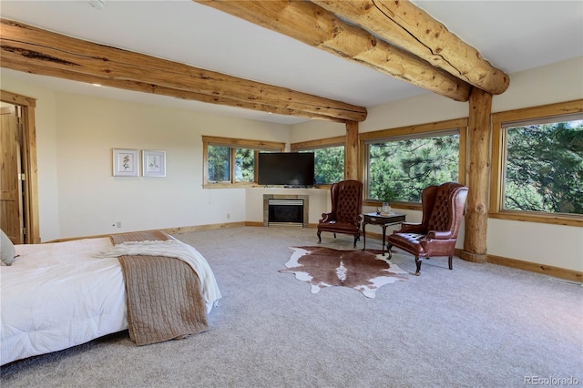 4440 Monitor Rock Ln, Colorado Springs, CO 80904 - carpeted bedroom with multiple windows, beamed ceiling, and a fireplace