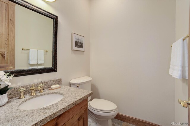 4440 Monitor Rock Ln, Colorado Springs, CO 80904 - half bathroom featuring toilet and vanity