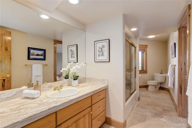 4440 Monitor Rock Ln, Colorado Springs, CO 80904 - bathroom featuring vanity, shower / bath combination with glass door, and recessed lighting
