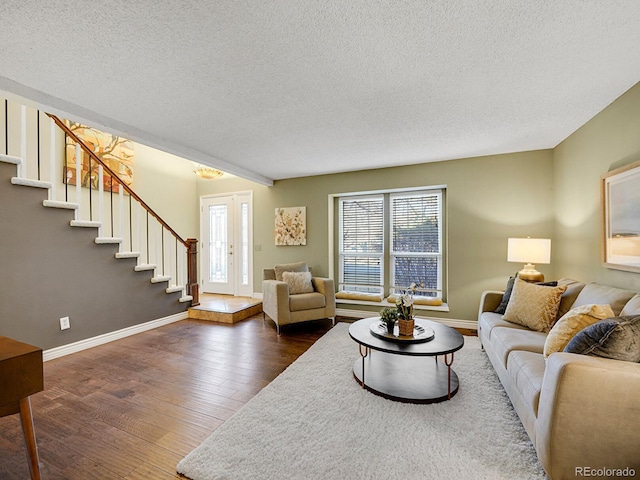 living area featuring baseboards, a textured ceiling, stairway, and dark wood-style flooring