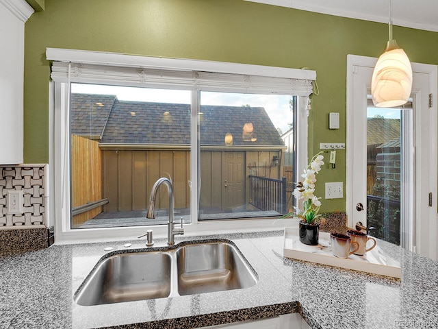 kitchen featuring a sink and pendant lighting