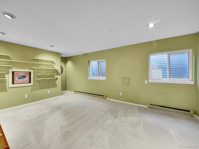 carpeted spare room featuring a baseboard heating unit, a baseboard radiator, visible vents, and baseboards