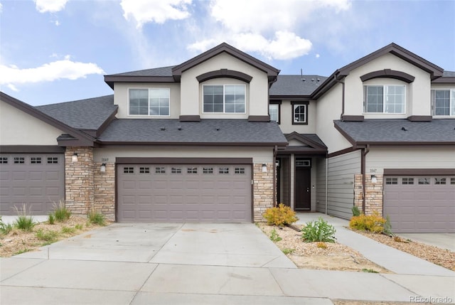 view of front of home featuring stone siding and stucco siding