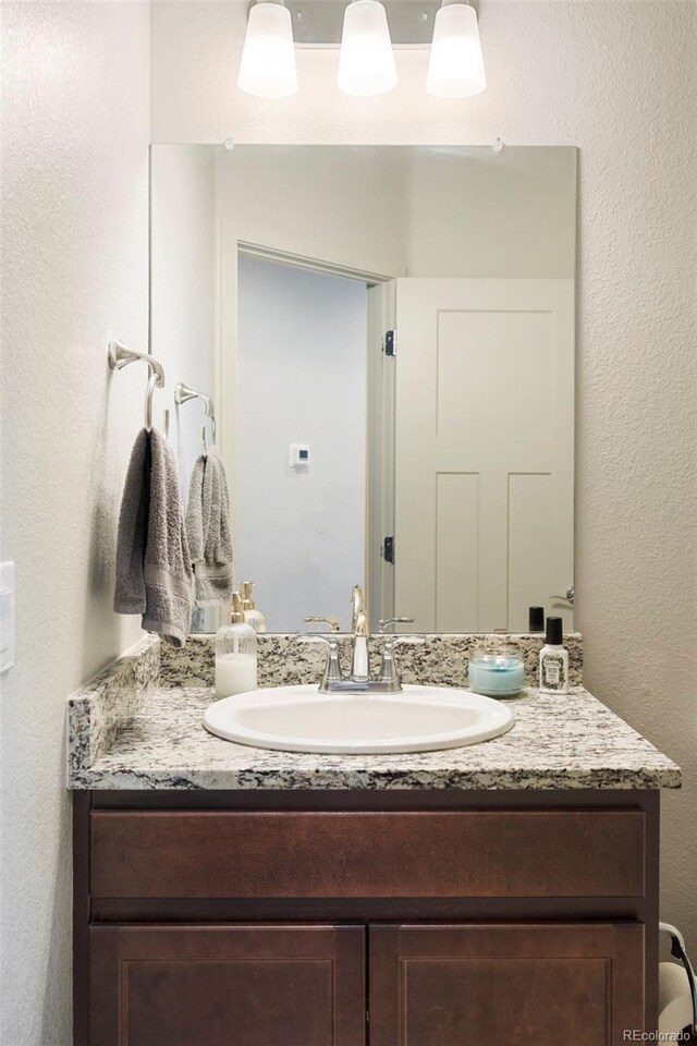 1849 S Helena St, Aurora, CO 80017 - bathroom with vanity and a textured wall