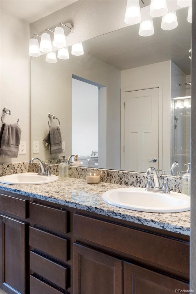 full bath with a stall shower and double vanity