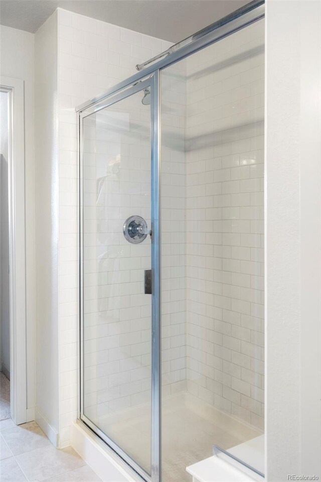 1849 S Helena St, Aurora, CO 80017 - bathroom featuring a shower stall and tile patterned floors