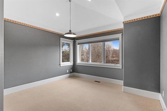 spare room with lofted ceiling and carpet flooring