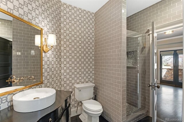 bathroom with vanity, a tile shower, and toilet