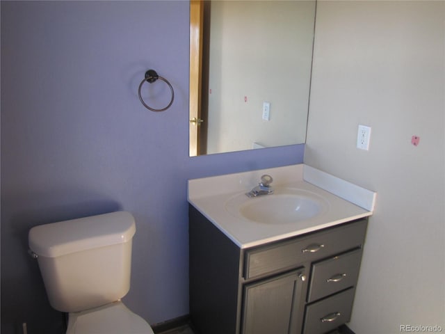 bathroom featuring vanity and toilet