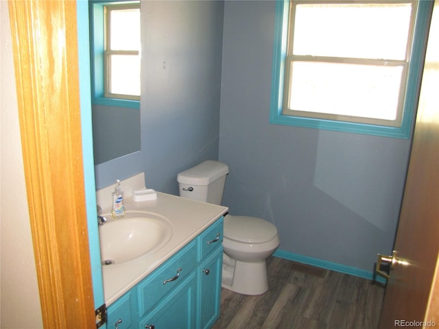 bathroom with vanity, toilet, and wood-type flooring