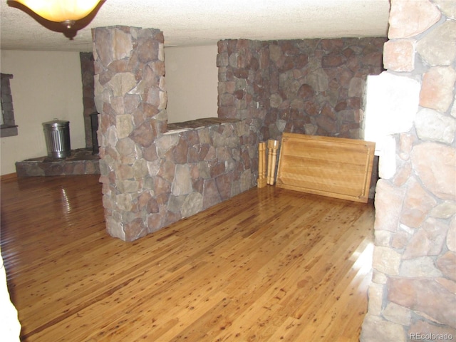 living room featuring a textured ceiling and hardwood / wood-style flooring