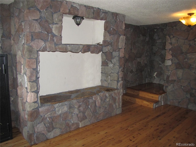 living room featuring a textured ceiling and hardwood / wood-style floors