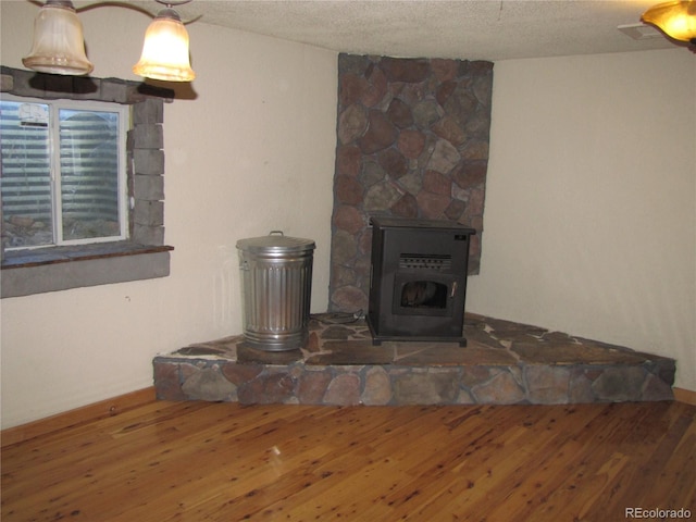 details featuring a fireplace, a textured ceiling, and hardwood / wood-style flooring