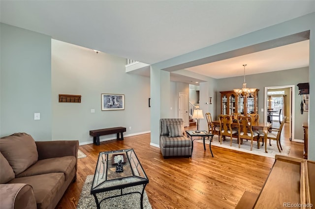 living room featuring wood-type flooring and a chandelier