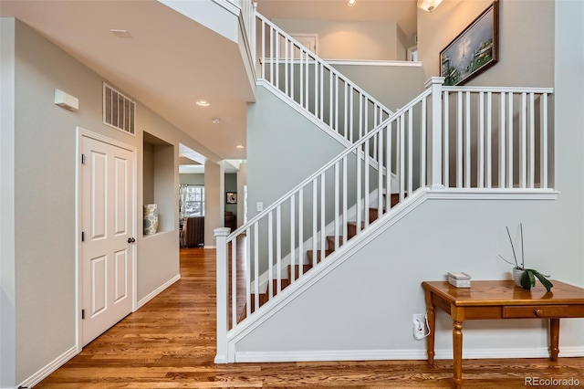 staircase with hardwood / wood-style flooring