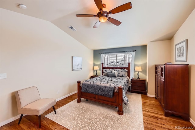 bedroom featuring lofted ceiling, light hardwood / wood-style flooring, and ceiling fan