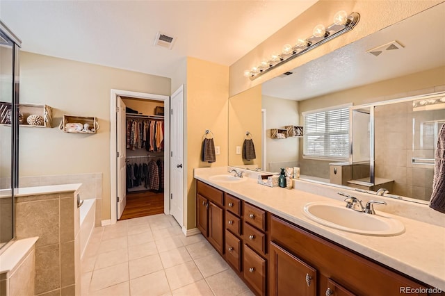 bathroom with vanity, tile patterned floors, and shower with separate bathtub