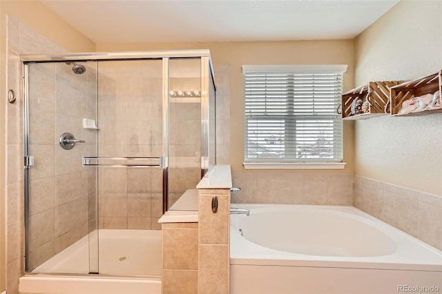 bathroom featuring shower with separate bathtub