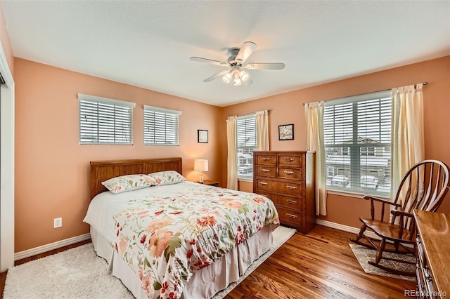 bedroom with hardwood / wood-style flooring and ceiling fan