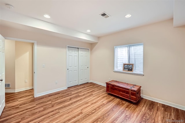 bedroom featuring light wood-type flooring and a closet