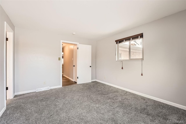 unfurnished bedroom featuring carpet floors, visible vents, and baseboards