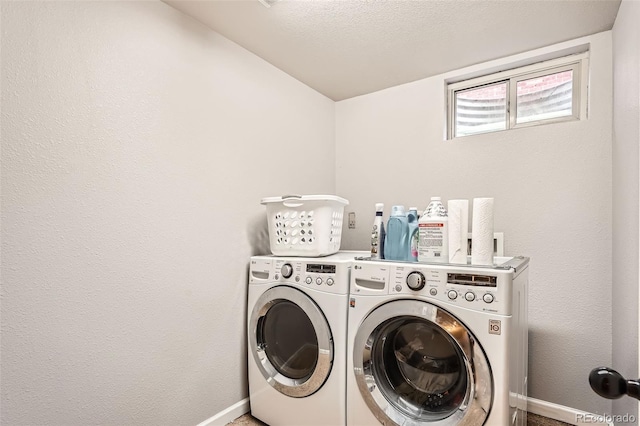 laundry room featuring laundry area, baseboards, a textured ceiling, and washing machine and clothes dryer