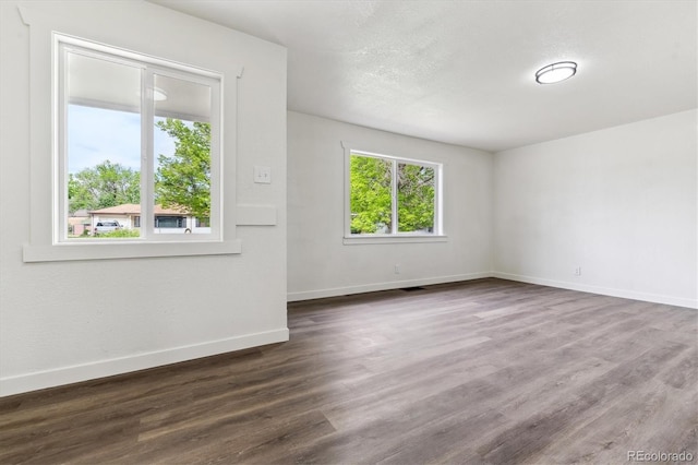1032 Geneva, Aurora, CO 80010 - unfurnished room with baseboards and dark wood-style flooring