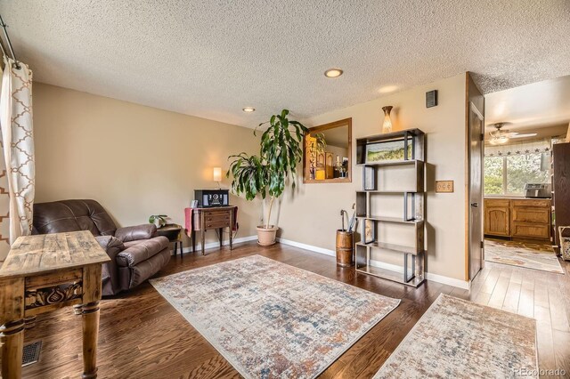 13661 W Tufts Ave, Morrison, CO 80465 - living area with ceiling fan, a textured ceiling, recessed lighting, baseboards, and wood finished floors