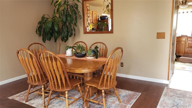 13661 W Tufts Ave, Morrison, CO 80465 - dining space featuring baseboards and wood finished floors