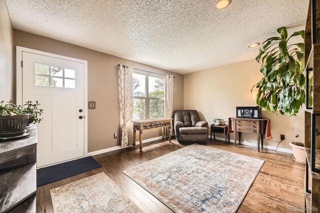 13661 W Tufts Ave, Morrison, CO 80465 - entrance foyer with baseboards, a textured ceiling, and wood finished floors
