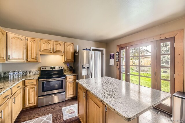 13661 W Tufts Ave, Morrison, CO 80465 - kitchen featuring a center island, light stone countertops, light brown cabinets, stainless steel appliances, and dark wood-type flooring