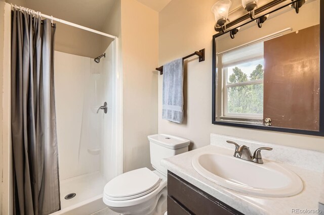 13661 W Tufts Ave, Morrison, CO 80465 - full bathroom featuring vanity, toilet, and a shower stall