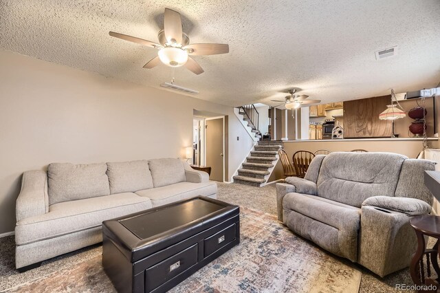 13661 W Tufts Ave, Morrison, CO 80465 - living area with ceiling fan, carpet, stairs, and visible vents