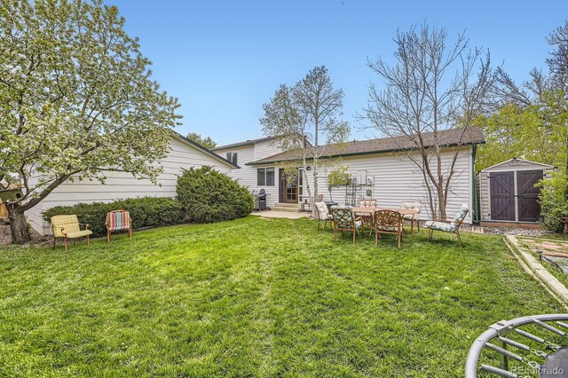 13661 W Tufts Ave, Morrison, CO 80465 - back of house featuring a storage shed, a yard, an outdoor structure, and entry steps