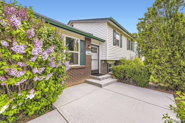 13661 W Tufts Ave, Morrison, CO 80465 - view of exterior entry with brick siding and a patio area