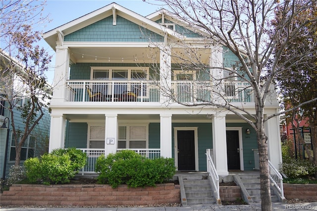 view of front facade with covered porch and a balcony