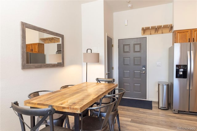 dining space with light wood-type flooring