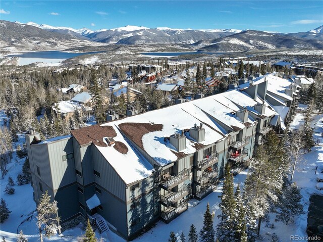 snowy aerial view featuring a mountain view