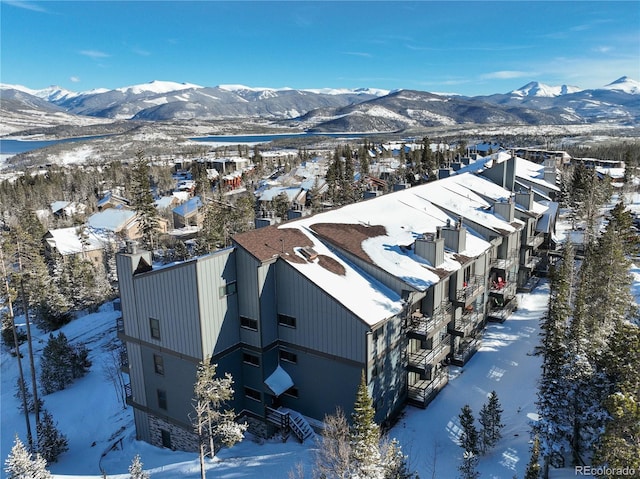 snowy aerial view with a residential view and a mountain view