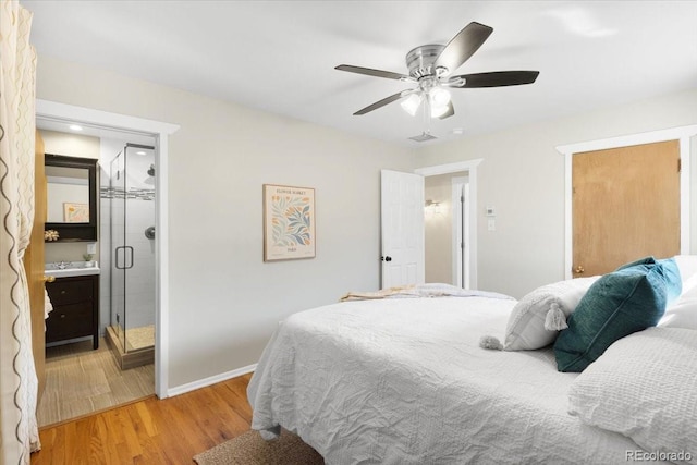 6314 Brooks Dr, Arvada, CO 80004 - bedroom featuring light wood-type flooring, baseboards, a sink, ceiling fan, and connected bathroom