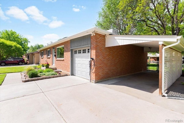 6314 Brooks Dr, Arvada, CO 80004 - view of side of home with concrete driveway, brick siding, an attached garage, and an attached carport
