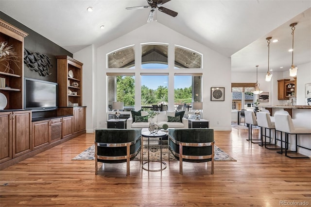 13962 W 76th Ln, Arvada, CO 80005 - living area featuring light wood finished floors, lofted ceiling, a ceiling fan, and recessed lighting