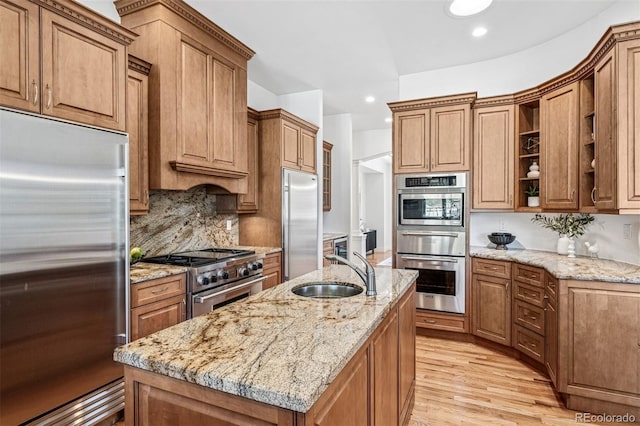 13962 W 76th Ln, Arvada, CO 80005 - kitchen with high quality appliances, a warming drawer, light wood-style floors, tasteful backsplash, and light stone counters