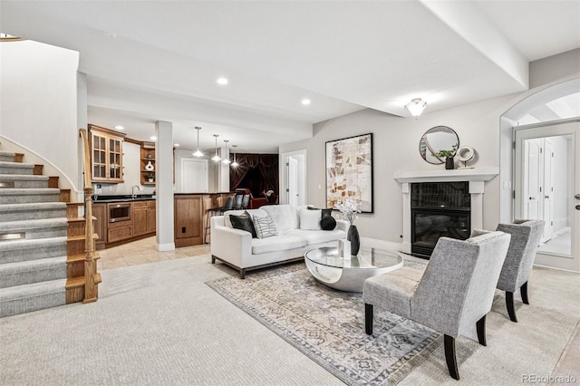 13962 W 76th Ln, Arvada, CO 80005 - living area with recessed lighting, stairway, light carpet, and a glass covered fireplace