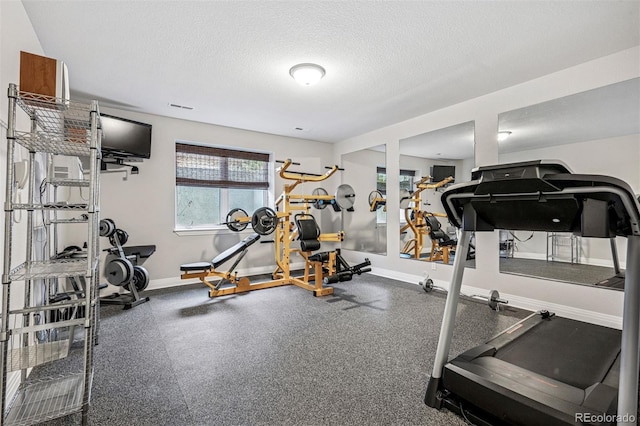 13962 W 76th Ln, Arvada, CO 80005 - exercise area featuring a textured ceiling and baseboards