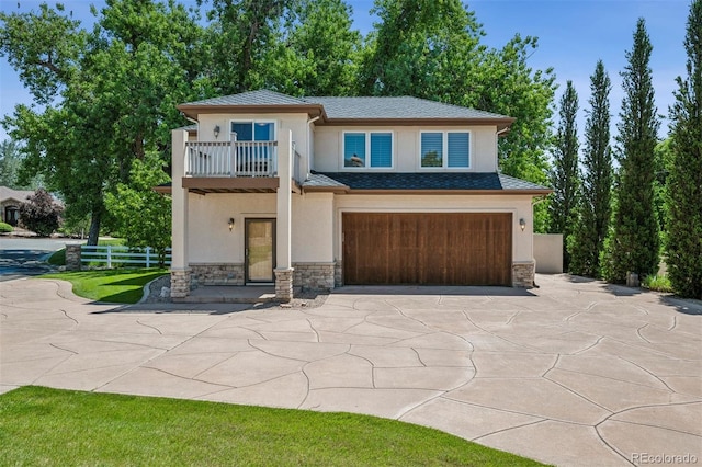 13962 W 76th Ln, Arvada, CO 80005 - view of front facade with a balcony, stucco siding, stone siding, and an attached garage