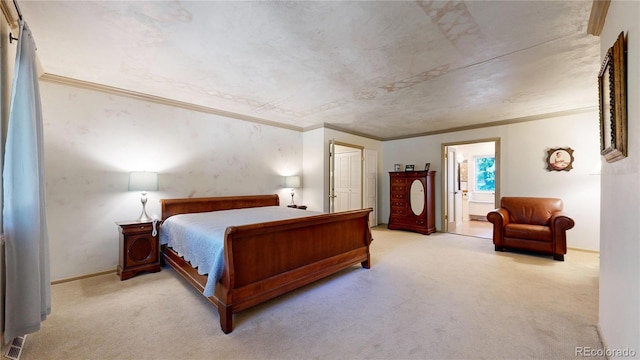 bedroom featuring carpet, ornamental molding, and ensuite bath