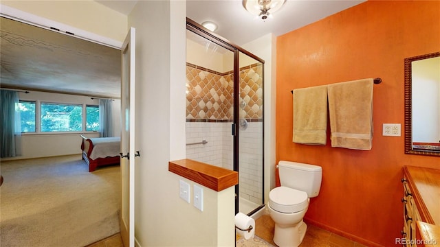 bathroom featuring a shower with door, vanity, and toilet